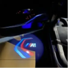 Automotive welcome lighting projecting a brand logo beside the car door