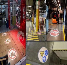 Industrial safety projections marking hazards and walkways on factory floors